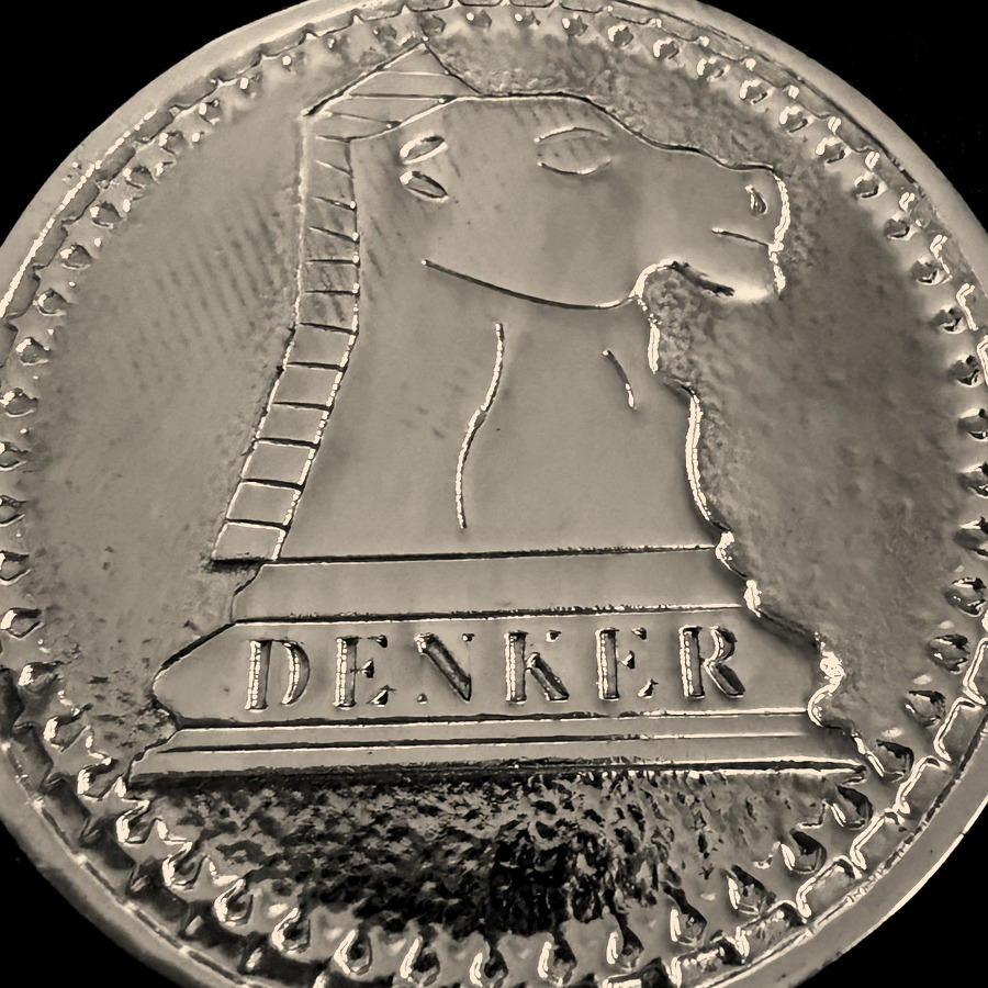 A gold Denker Tournament of High School Champions medal, a knight in relief above the word DENKER.