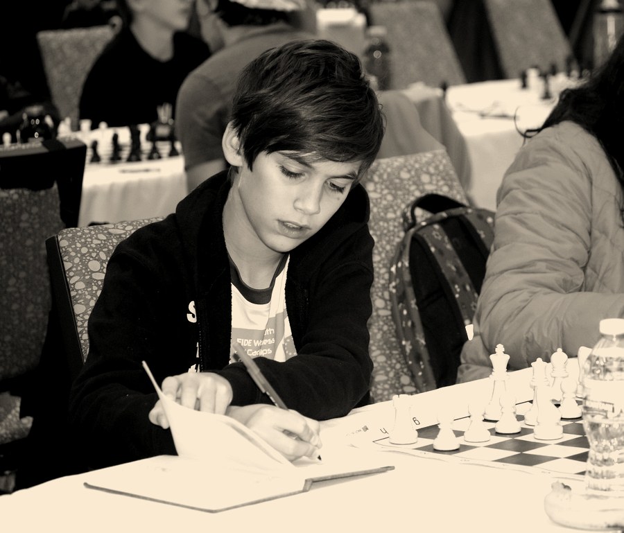 Gabriel Eidelman writing his move on a scoresheet during a tournament game.