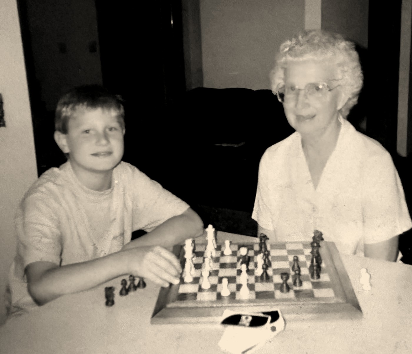 Daniel Vellotti as a boy, playing chess at a kitchen table with his grandmother Marcella Tomei.